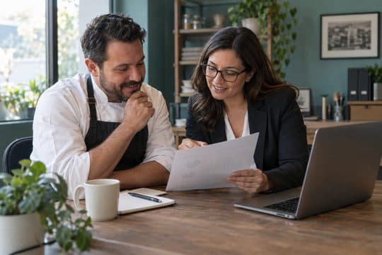 An owner going over a summary with an accountant